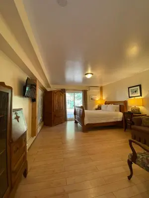 a large room with a bed and a couch at Timber House Resort in Brighton