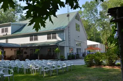 a group of chairs in front of a building at Timber House Resort in Brighton