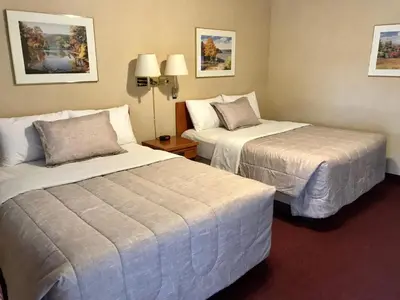 a hotel room with two beds in a room at Country Inn Listowel in Listowel