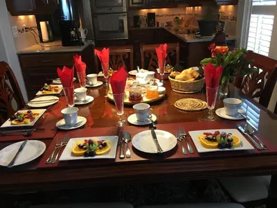 a wooden table with plates of food on it at Graystone Bed & Breakfast in Niagara on the Lake