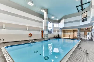 a large pool with blue water in a building at Best Western Plus Cambridge Hotel in Cambridge