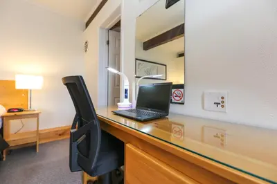 a laptop computer sitting on a desk in a room at Lakeview Motel in Haliburton