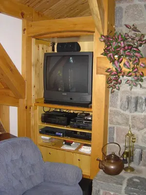 a living room with a tv and a blue chair at Sunny Rock Bed & Breakfast in Minden