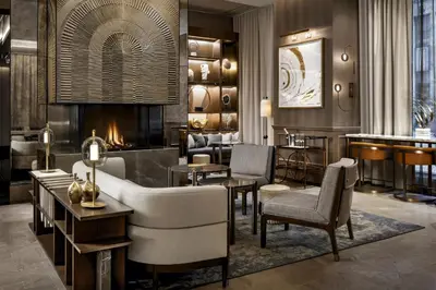 a lobby with a couch and chairs and a fireplace at The St. Regis Toronto in Toronto