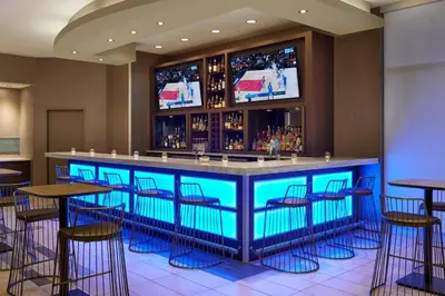 a bar with blue bar stools in a restaurant at SpringHill Suites by Marriott Toronto Vaughan in Vaughan