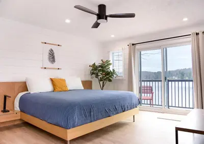 a bedroom with a bed and a ceiling fan at Bonnie View Inn in Haliburton