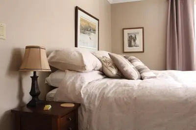 a bedroom with a bed with pillows and a lamp at Tailwinds B&B in Erin