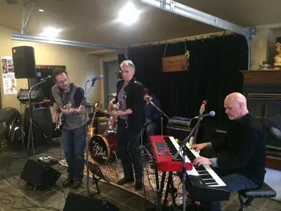 a group of people playing music in a room at Dominion Hotel in Minden