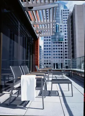 a group of chairs and tables on a building balcony at Le Germain Hotel Toronto in Toronto