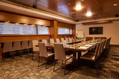 a large conference room with a long table and chairs at Le Germain Hotel Toronto in Toronto
