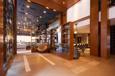 a lobby of a store with a chair and tables at Le Germain Hotel Toronto in Toronto
