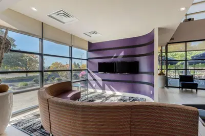 a living room with a couch and a tv at C Hotel by Carmen's, BW Premier Collection in Hamilton
