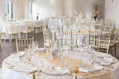 a table set up for a wedding with glasses and napkins at C Hotel by Carmen's, BW Premier Collection in Hamilton