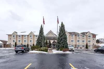 a large building with cars parked in a parking lot at Best Western Plus Woodstock Inn & Suites in Woodstock