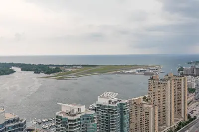 an aerial view of a large body of water with buildings at Executive Corner Suite with Panoramic View in Toronto