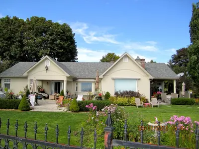 a house with a fence in the yard at Willowmere in Cobourg