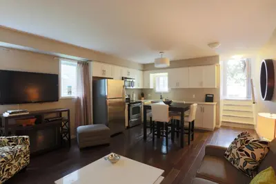 a living room with a kitchen and a dining room at Boardwalk Homes - Vacation Homes & Executive Suites in Kitchener
