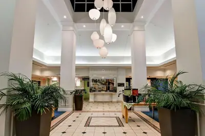 a lobby with two potted plants in a building at Hilton Garden Inn Toronto/Mississauga in Mississauga