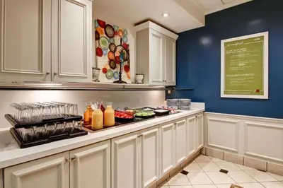 a kitchen with a counter with drinks on it at Hilton Garden Inn Toronto/Mississauga in Mississauga