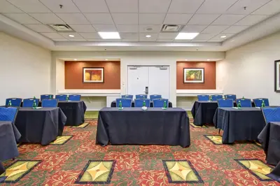 a conference room with blue tables and blue chairs at Hilton Garden Inn Toronto/Mississauga in Mississauga
