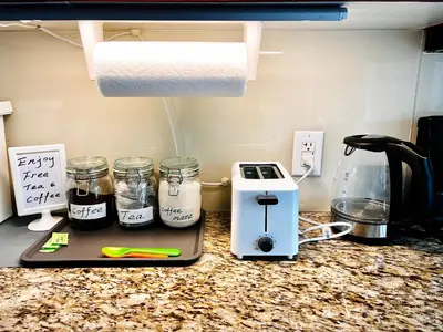 a kitchen counter with a toaster and two jars of food at Home in Downtown in Toronto