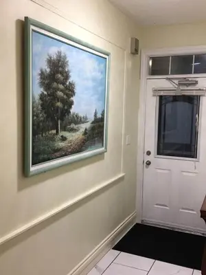 a painting on a wall next to a white door at Village at York U in Toronto