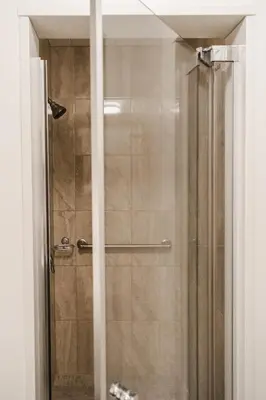 a shower with a glass door in a bathroom at Evanndor in Stratford