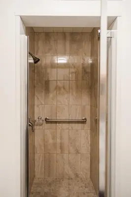 a shower with a glass door in a bathroom at Evanndor in Stratford