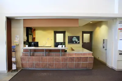 a lobby with a brick counter in a building at Residence & Conference Centre- Barrie in Barrie