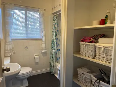 a bathroom with a toilet and a sink at Cozy House B&B in Niagara Falls