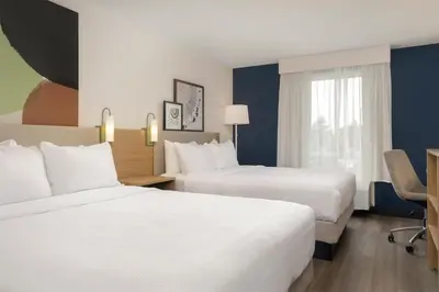 a hotel room with two beds and a window at Spark By Hilton Woodstock in Woodstock