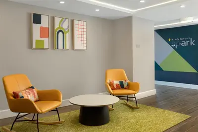two chairs and a table in a waiting room at Spark By Hilton Woodstock in Woodstock