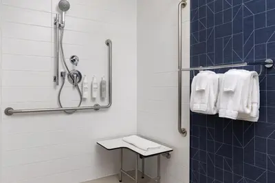 a bathroom with a shower with white towels at Spark By Hilton Woodstock in Woodstock