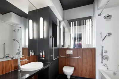 a bathroom with a sink and a toilet and a shower at Alt Hotel Toronto Airport in Mississauga