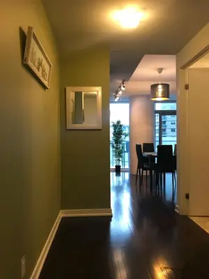 a dining room with green walls and a table at Stylish Condos Toronto in Toronto