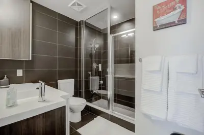 a bathroom with a toilet sink and a shower at CHOL Furnished Suites Heart of Downtown Toronto, 2 Beds, Free Parking, CN Tower View in Toronto