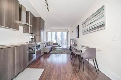 a kitchen with a table and chairs in a room at CHOL Furnished Suites Heart of Downtown Toronto, 2 Beds, Free Parking, CN Tower View in Toronto