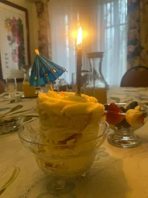 a cake with a candle in a bowl on a table at Blue Spruce Bed and Breakfast Muskoka in Gravenhurst