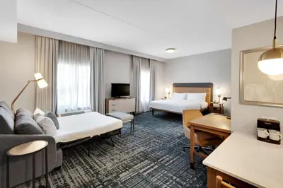 a hotel room with two beds and a desk at Homewood Suites by Hilton Toronto-Markham in Markham