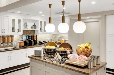 a kitchen with a counter with bowls of food on it at Homewood Suites by Hilton Toronto-Markham in Markham