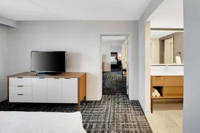 a bedroom with a television on a dresser with a sink at Homewood Suites by Hilton Toronto-Markham in Markham