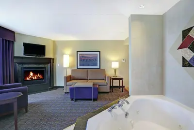 a living room with a tub and a fireplace at Homewood Suites by Hilton Cambridge-Waterloo, Ontario in Cambridge