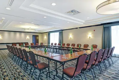 a conference room with a long table and chairs at Homewood Suites by Hilton Cambridge-Waterloo, Ontario in Cambridge