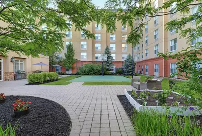 a courtyard of a building with a patio with flowers at Homewood Suites by Hilton Cambridge-Waterloo, Ontario in Cambridge