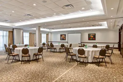 a conference room with tables and chairs and a whiteboard at Hilton Garden Inn Toronto/Burlington in Burlington