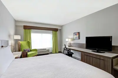 a hotel room with a bed and a flat screen tv at Hilton Garden Inn Toronto/Ajax in Ajax
