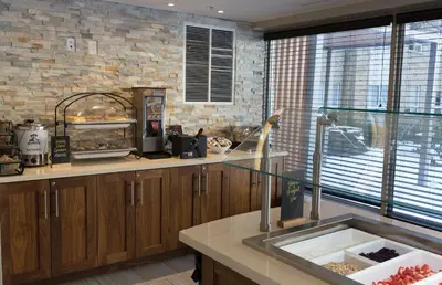 a kitchen with a sink and a brick wall at Staybridge Suites Toronto - Vaughan South by IHG in Vaughan