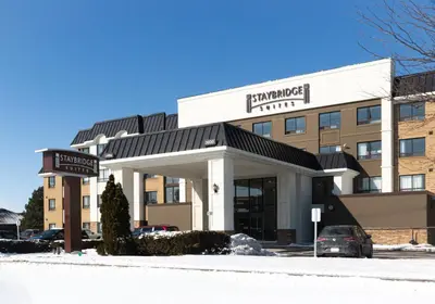 a hotel building with a sign in front of it at Staybridge Suites Toronto - Vaughan South by IHG in Vaughan