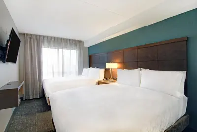 a hotel room with two beds and a window at Staybridge Suites Toronto - Vaughan South by IHG in Vaughan