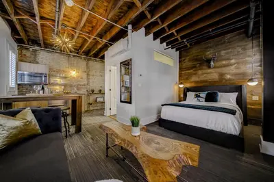 a bedroom with a bed and a couch and a table at The Westlake in Toronto